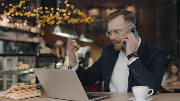 Businessman Talking Via Smartphone with Colleague Arguing