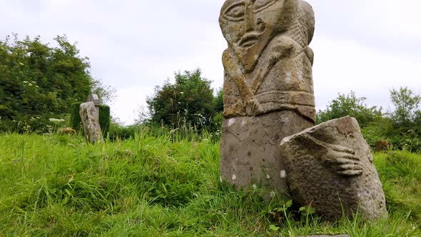 This is a Bronze Age Stone Carviing with Two Facescalled Janus Located In Caldragh Cemetery on Boa