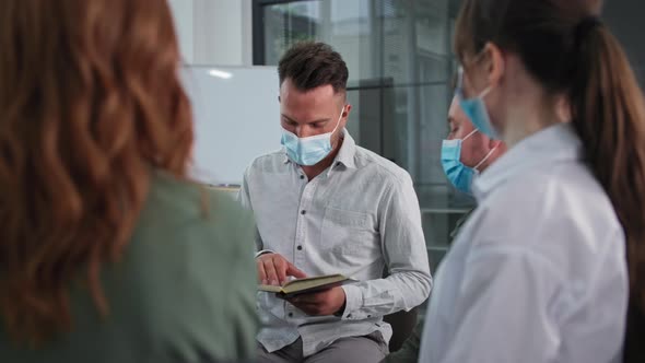 Christian Group of Men and Women Wearing Medical Masks Observe Precautions While Worshiping God and