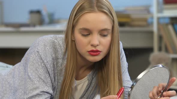 Cute Teenage Girl Applying Red Lipstick, Feeling Pretty and Self-Confident