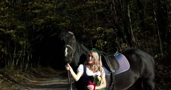 Slavic Girl Sniffs a Bouquet of Wild Flowers and Poses at Black Horse Outside