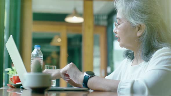 Active Senior Asian Woman Working in a Coffeeshop 06