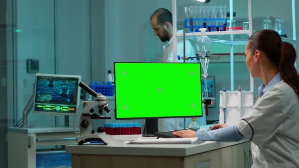 Biochemist Sitting at Workplace Using Green Mockup Screen Pc