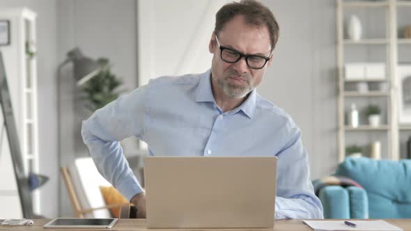 Senior Aged Businessman with Spinal Back Pain at Work