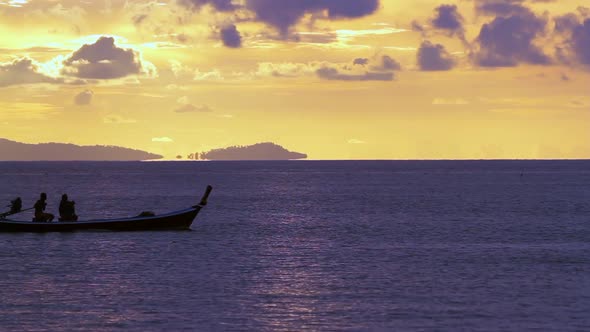 Long tailed boat in sunset scenery