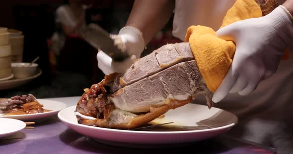 Chef cutting of grilled duck in restaurant