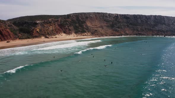 Aerial footage of surfers on the west coast of Portugal.