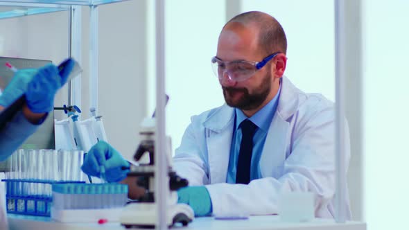 Doctor Dictating To Nurse Virus Results Informations Looking on Test Tubes