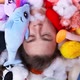 Plump Man Lies in Heap of Plush Toys and Stuffing Closeup - VideoHive Item for Sale