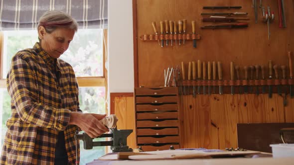 Female luthier at work in her workshop