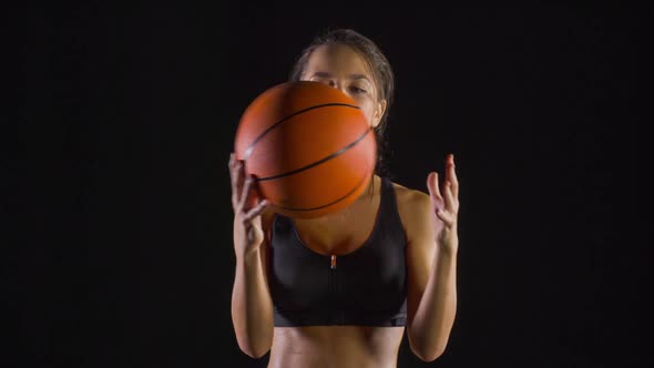 Athletic woman playing basketball