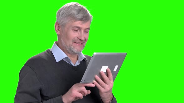 Happy Caucasian Man Using Computer Tablet.