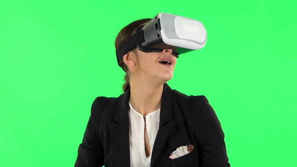 Happy Young Woman with Virtual Reality Headset or 3d Glasses. Green Screen