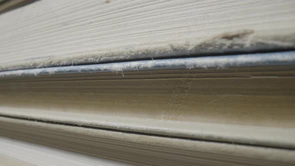 Macro of a Stack of Old Books with Gray Shabby Covers and Yellowed Pages