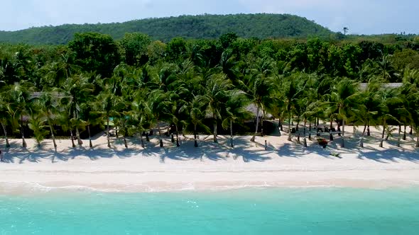 Wide aerial view of beautiful palm tree beach with white sand and turquoise blue sea White beach, Pa