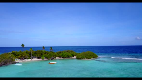 Aerial drone view tourism of tropical coastline beach break by turquoise lagoon with white sand back