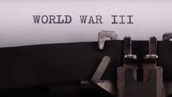 Typing phrase "WORLD WAR III" on retro typewriter.