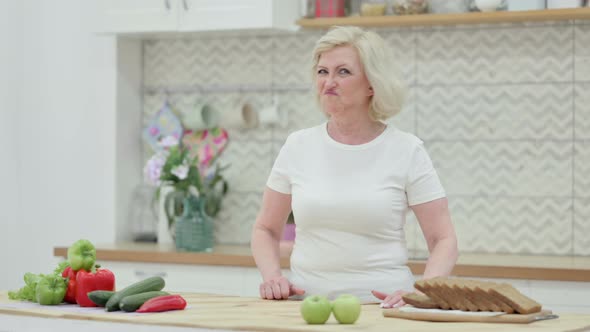 Senior Old Woman Shaking Head As No Sign While in Kitchen