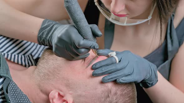 Master Beautician Does Eyebrow Tattoo