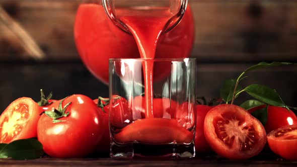 Super Slow Motion Tomato Juice Poured From Jug Into a Glass