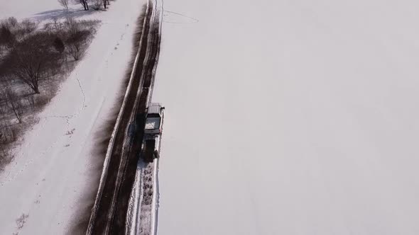 Vast Farmland In Deep Snow With Running Truck Pulling A Manure Spreader In Southeast Michigan. - Aer