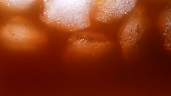 Floating Ice Cubes in Coffee with Milk Close Up