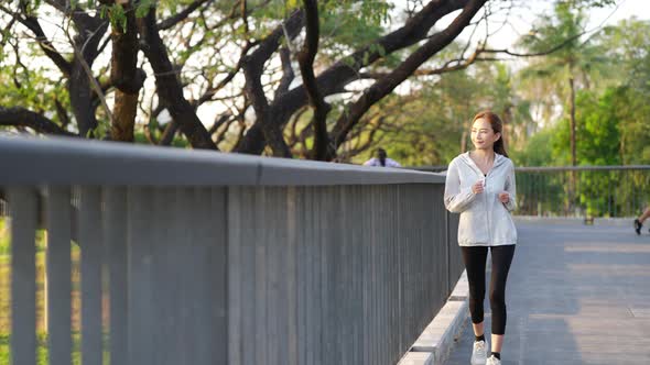 4K Asian woman jogging exercise at public park in the morning