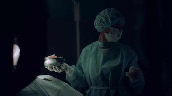 Nurse Handing Surgical Instruments Helping Doctor in Hospital Emergency Ward