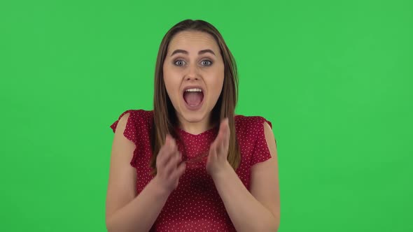Portrait of Tender Girl in Red Dress Is Frustrated Saying Oh My God and Being Shocked. Green Screen