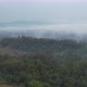 Aerial landscape view of greenery rainforest and hills on foggy day by drone - VideoHive Item for Sale