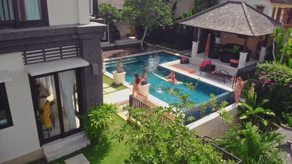 Flight Overlooking the Villa and Girls Near Uluwatu Town on Bali Island Indonesia