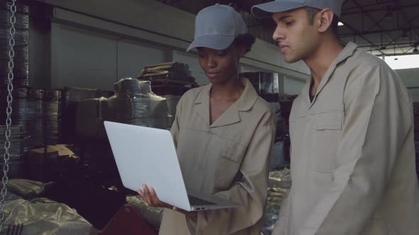 Young warehouse workers interacting