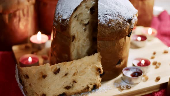 Powdered Sugar on the Top of Delicious Panettone of Milan in a Beautiful Atmosphere of Candles