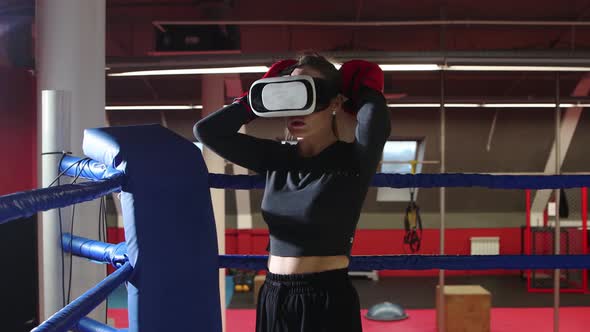 A Young Woman Trains Her Punches Wearing VR Glasses