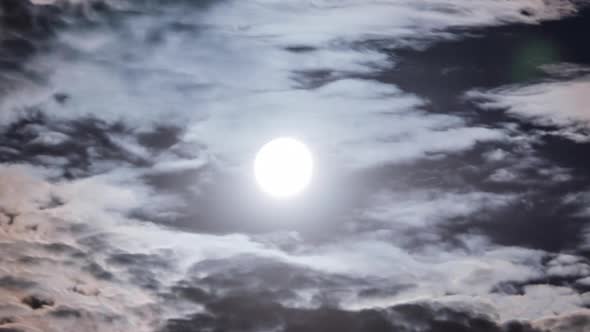 Full Moon Moves in the Night Sky Through Dark Clouds Timelapse