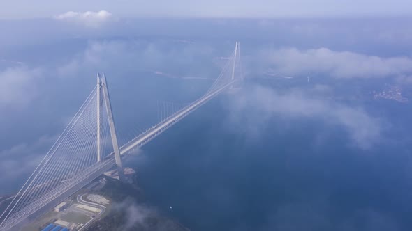 Aerial hyperlapse video of Yavuz Sultan Selim Bridge on a foggy day in Istanbul, Turkey.