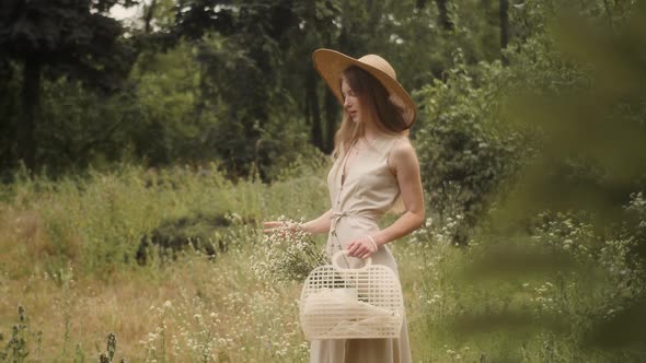 Woman with Flowers in Nature in the Summer