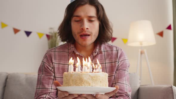 Close Up Portrait of Birthday Man Blowing Candles on Holiday Cake Slow Motion