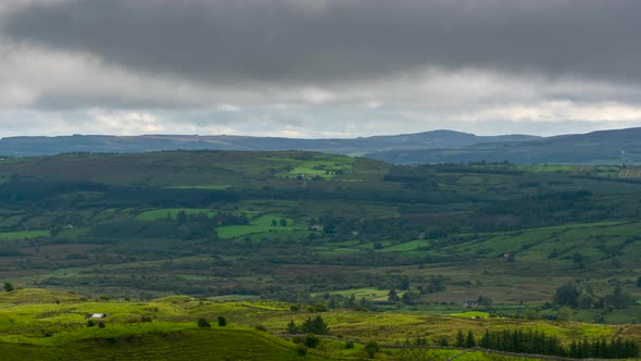 Time lapse of countryside landscape with hills and fields on a cloudy dramatic day in rural Ireland