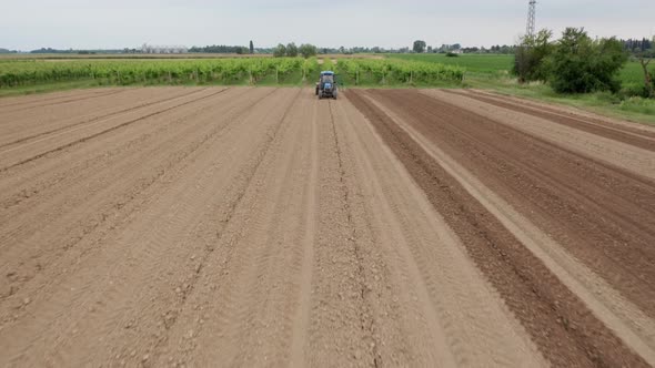 Tractor plows a field in Friuli Venezia Giulia, Italy