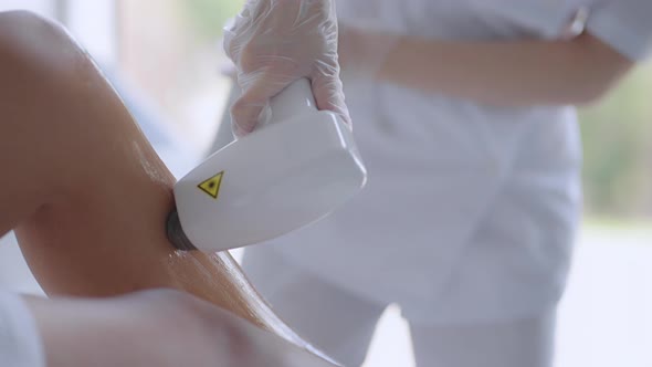 A Woman Lies on a Couch for a Laser Hair Removal Procedure