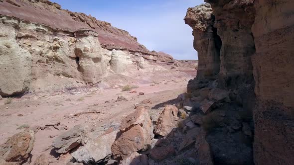 Slowly flying through dry desert was past cliff