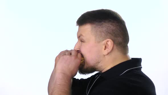 Young Man Eating a Cheeseburger. White. Slow Motion