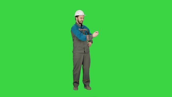 Smiling Man in Helmet Make Selfie on a Green Screen, Chroma Key