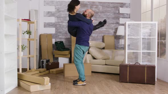 Excited Boyfriend Spining His Girlfriend in Their New Apartment