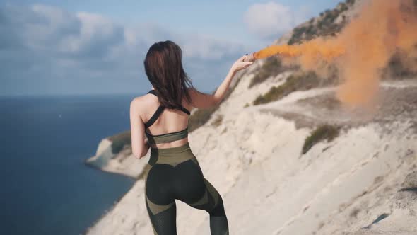 Slow Motion Back View of Beautiful Young Sportive Woman Stand on Cliff