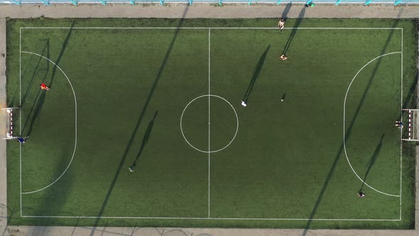 Top View of a Sports Football Field with Players Playing Football