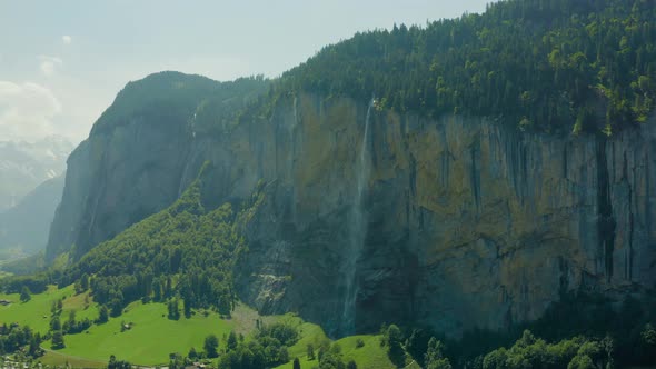 Iconic Waterfall Staubbachfall in Lauterbrunnen Switzerland, aerial pan