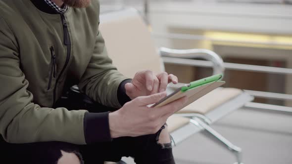 Man Typing on a Tablet Indoor