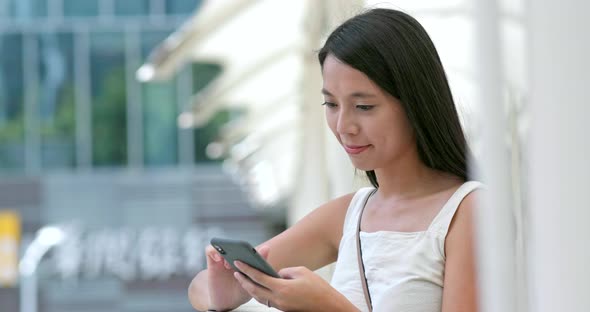 Young woman use of mobile phone in city